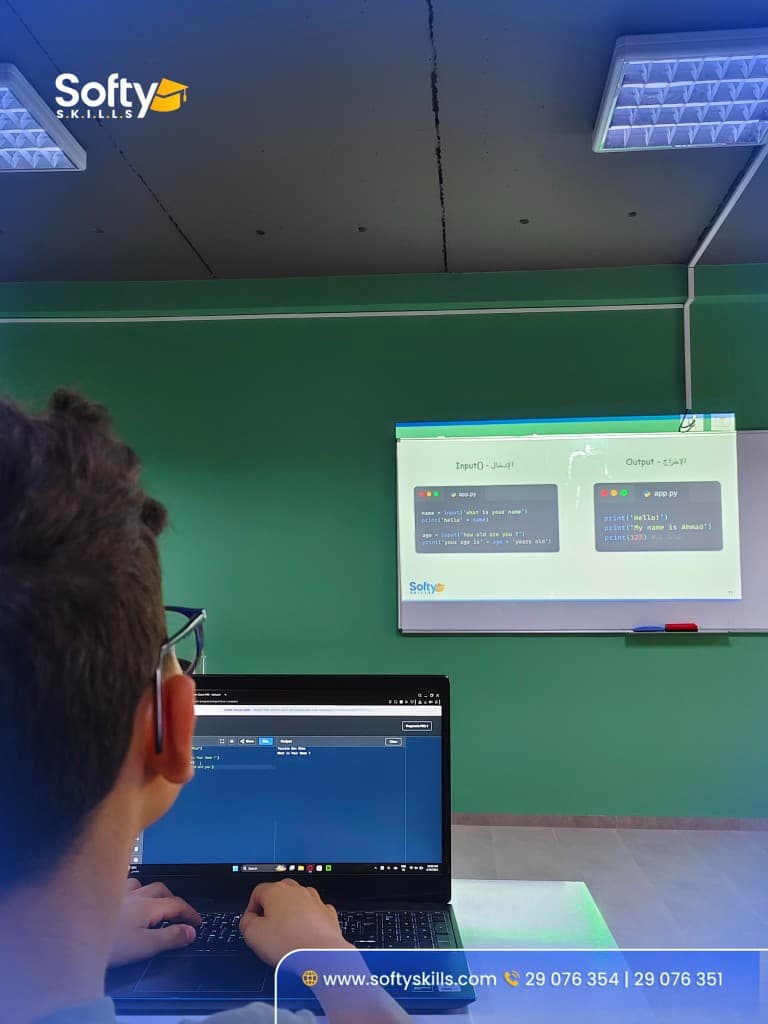 Student following a Python lesson on input and output
